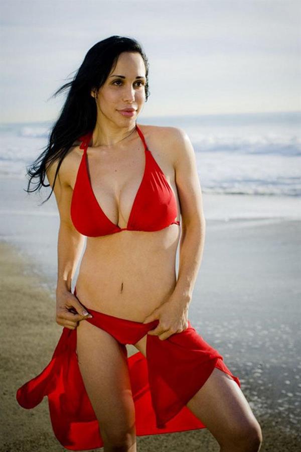 Nadya Suleman is better known as Octomom.  She was born Natalie Denise Suleman on July 11, 1975.  After 14 children she is stripping and making porn...

Octomom on a beach in a red bikini