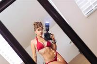 Tianna Gregory in a bikini taking a selfie