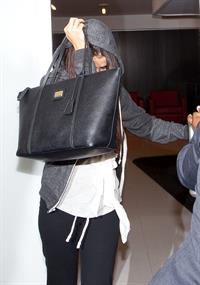 Selena Gomez departing out of LA, hiding her face