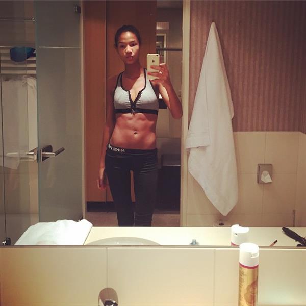Ariela Oliveira in a bikini taking a selfie
