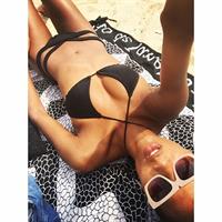 Ariela Oliveira in a bikini taking a selfie