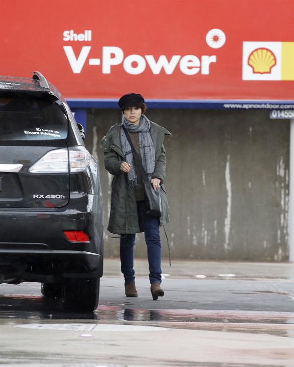 Dannii Minogue - Pictured getting a little wet while filling up on petrol - 09th August 2012