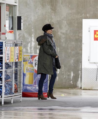 Dannii Minogue - Pictured getting a little wet while filling up on petrol - 09th August 2012
