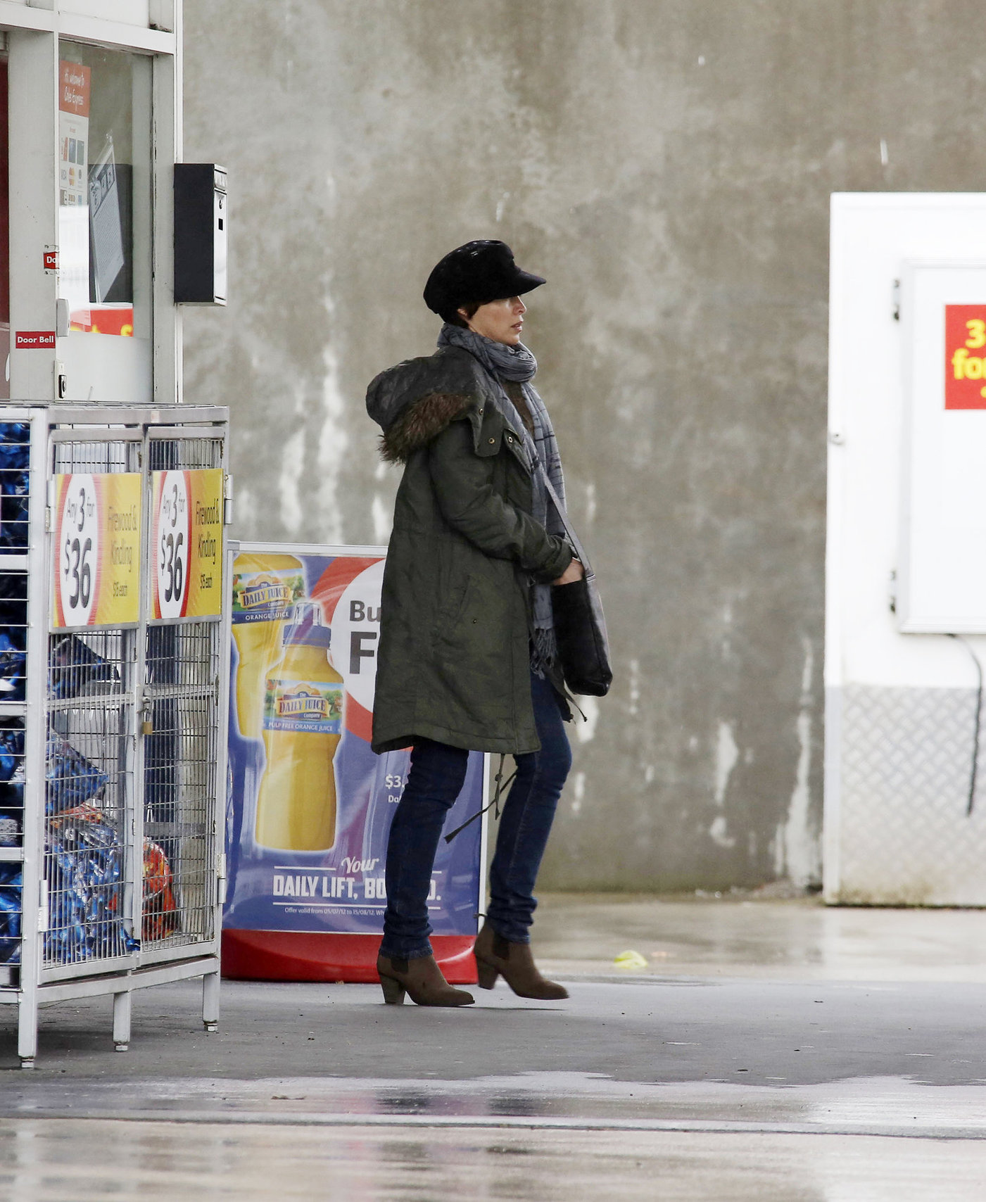 Dannii Minogue - Pictured getting a little wet while filling up on petrol - 09th August 2012