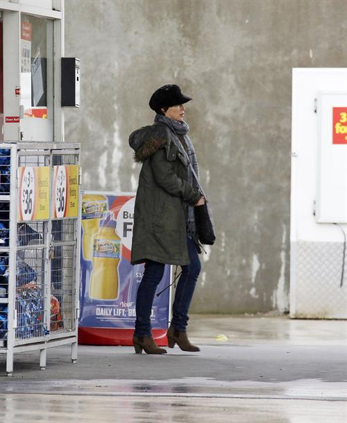 Dannii Minogue - Pictured getting a little wet while filling up on petrol - 09th August 2012