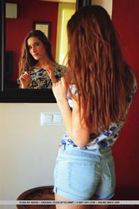 Elina in  Detarce  for MetArt - Elina strips on the couch baring her sexy hips and trimmed pussy.