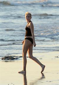 Miley Cyrus  yoga in black bikini on beach in Hawaii 1/24/13 