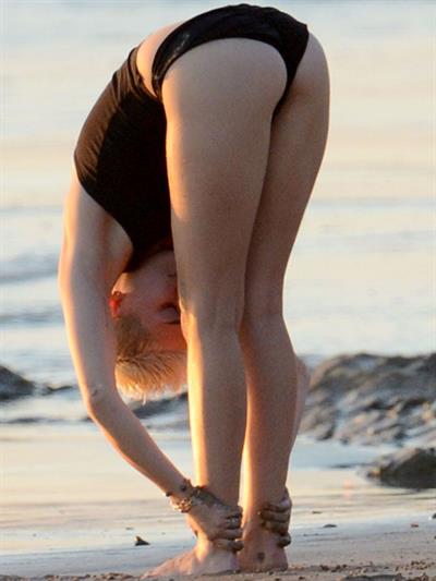 Miley Cyrus  yoga in black bikini on beach in Hawaii 1/24/13 