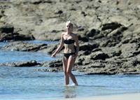 Miley Cyrus  yoga in black bikini on beach in Hawaii 1/24/13 