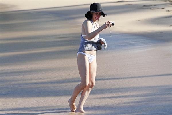 Milla Jovovich on the beach in a bikini on New Years Eve in Maui, Hawaii December 31, 2012 