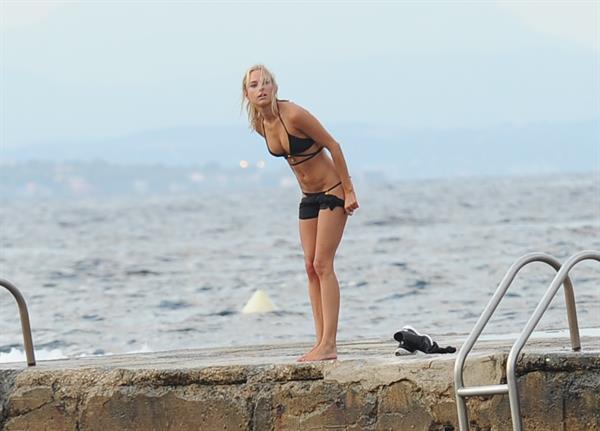 Kimberley Garner in a black bikini on the beach in St. Tropez on July 31, 2014