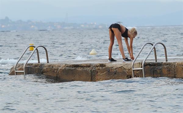 Kimberley Garner in a black bikini on the beach in St. Tropez on July 31, 2014