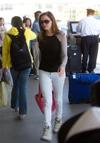Rose McGowan - Prepares to depart LAX carrying a pink handbag - June 6, 2012