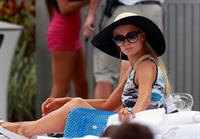 Paris Hilton spends the day in and out of the pool in Miami December 8, 2012
