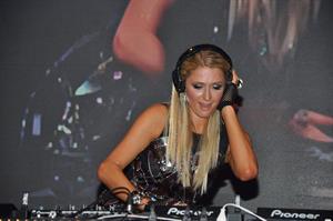Paris Hilton walks for designer duo Shane and Falguni Peacock and performs as a DJ at the India Resort Fashion Week
