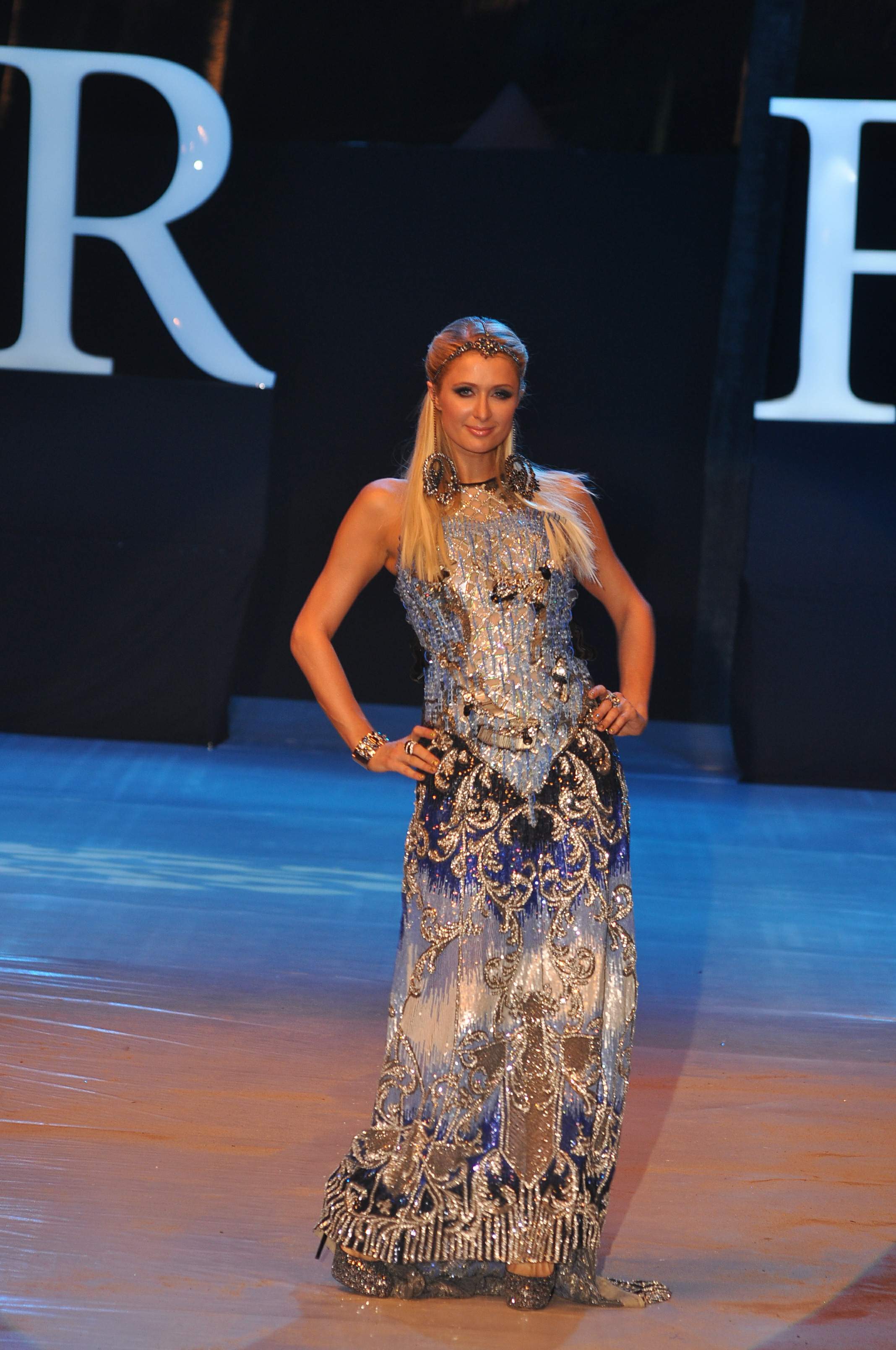 Paris Hilton walks for designer duo Shane and Falguni Peacock and performs as a DJ at the India Resort Fashion Week