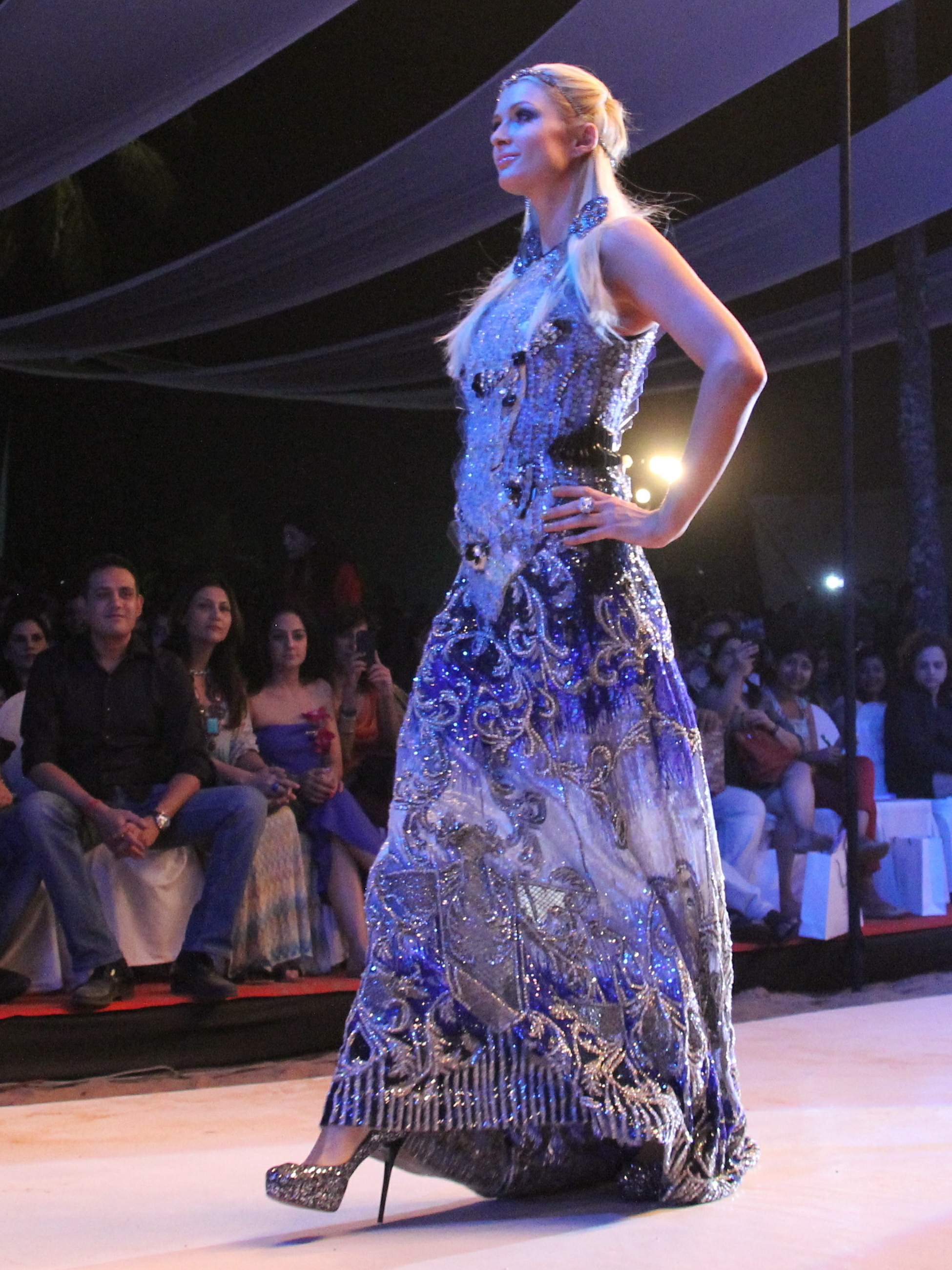 Paris Hilton walks for designer duo Shane and Falguni Peacock and performs as a DJ at the India Resort Fashion Week