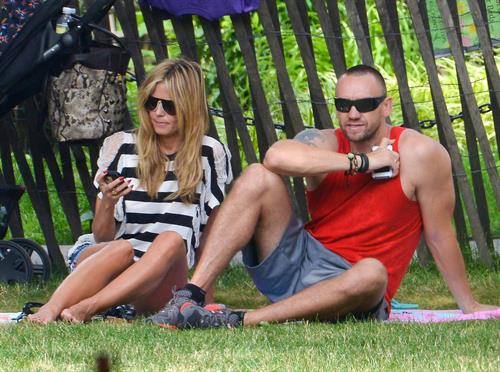 Heidi Klum in a black and white striped shirt, spends a day out in a park in Tribeca on June 30, 2013 