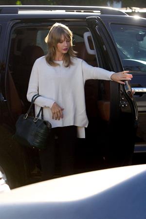 Taylor Swift wearing a white top and black pants in Los Angeles 10/28/13  