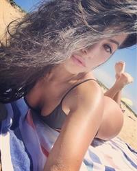 Mónica Alvarez in a bikini taking a selfie