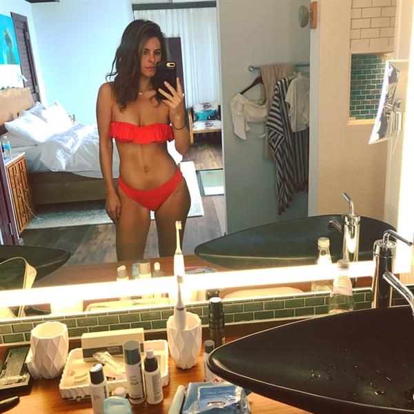 Maria Menounos in a bikini taking a selfie