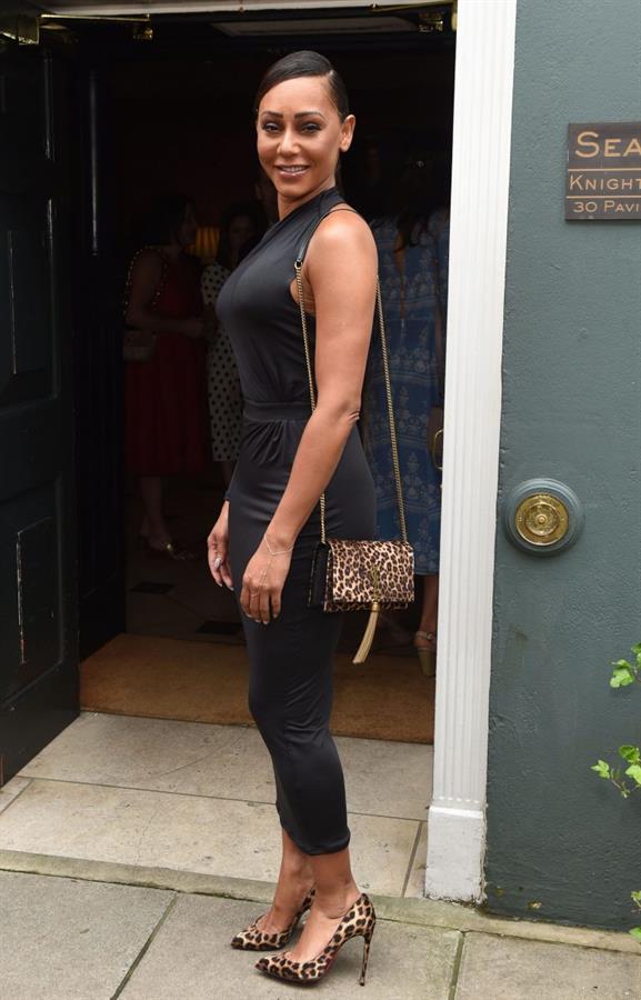 Mel B braless boobs in a black dress seen by paparazzi.






