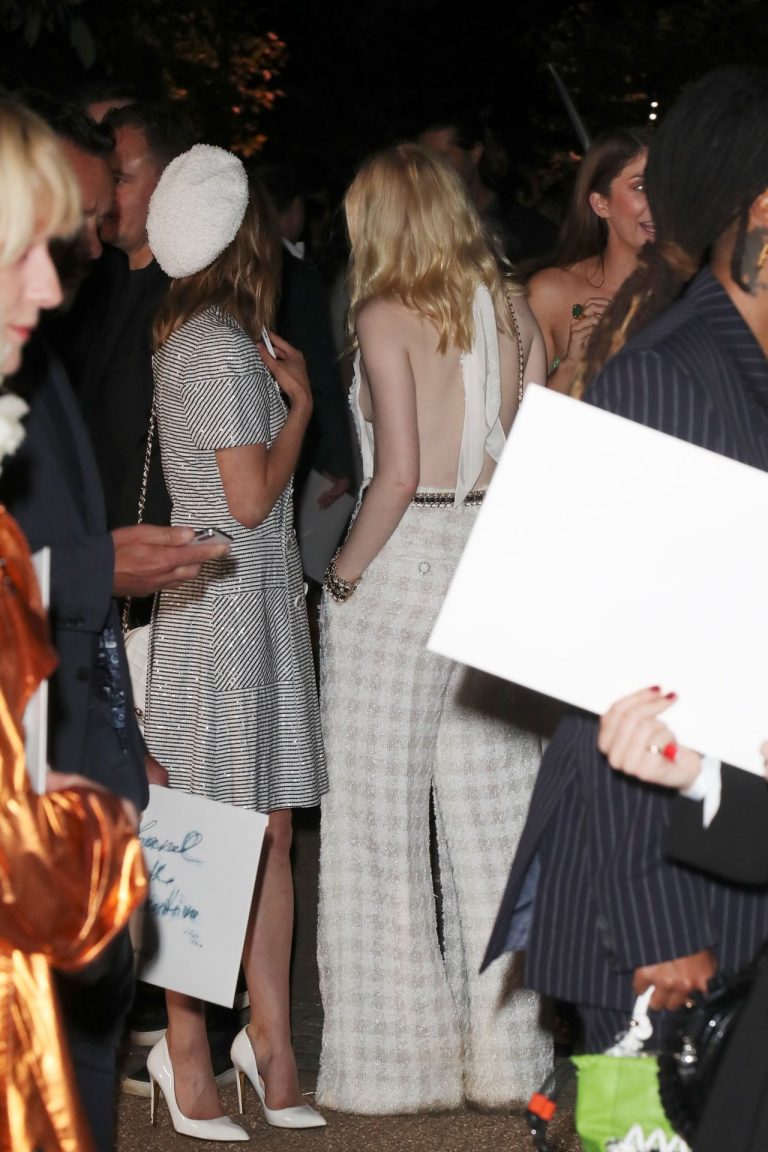 Ellie Bamber Pictures Ellie Bamber braless boobs while wearing basically a scarf as a top showing side boob cleavage.