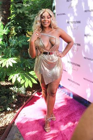 Ashanti sexy cleavage in a low cut dress at the PrettyLittleThings launch party.

