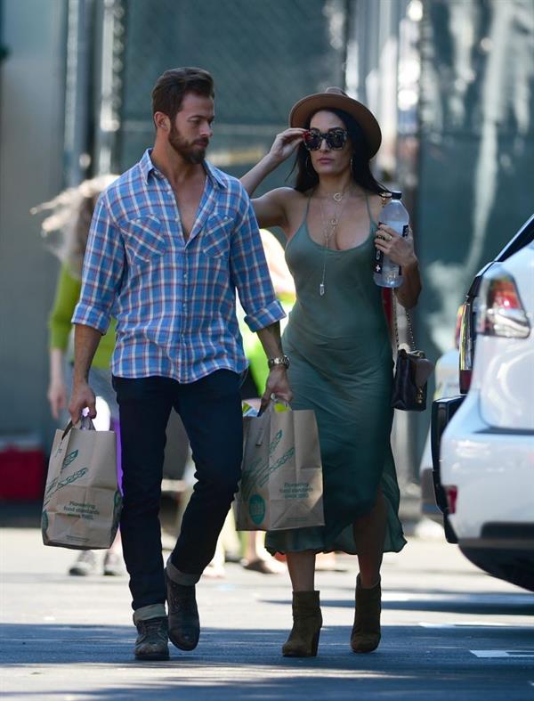 Nikki Bella braless boobs in a green dress seen by paparazzi.
















