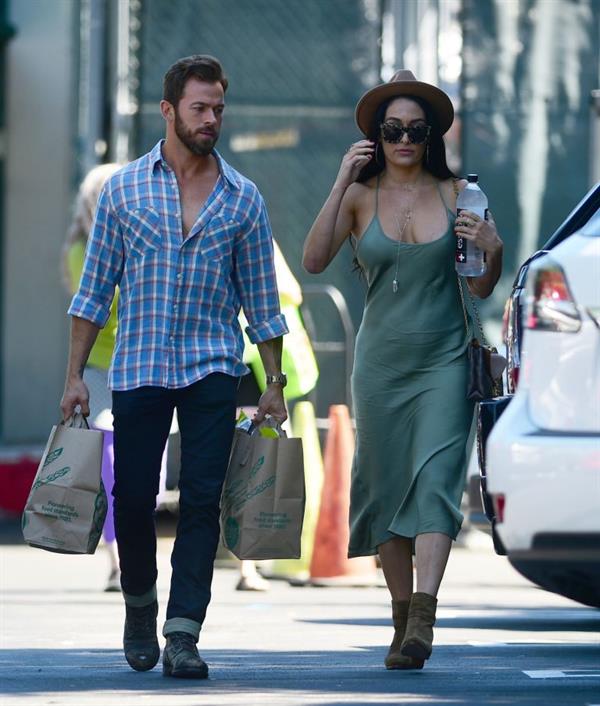 Nikki Bella braless boobs in a green dress seen by paparazzi.
















