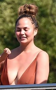 Chrissy Teigen sexy cleavage and ass in a swimsuit with her husband John Legend seen by paparazzi.
