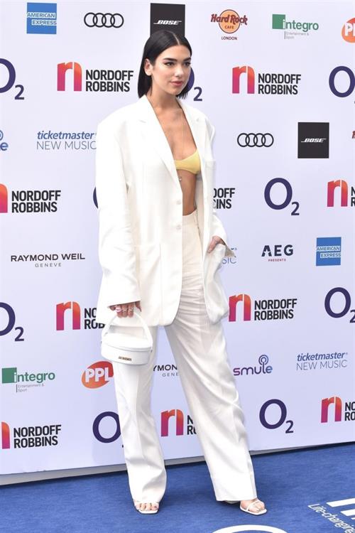 Dua Lipa looking hot in a sexy revealing top seen by paparazzi.





