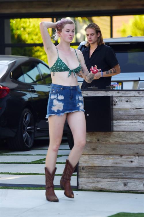 Ireland Baldwin Pictures Ireland Baldwin sexy in a bikini top seen by paparazzi showing some nice cleavage.
