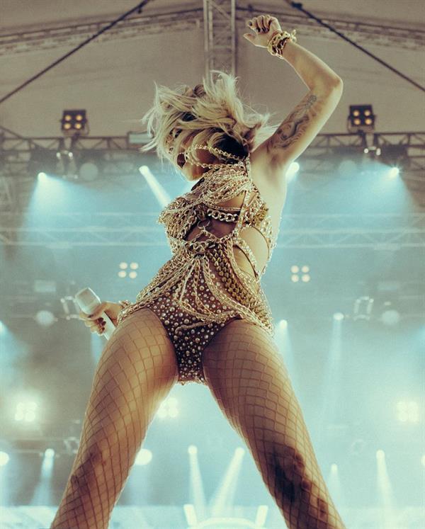Rita Ora sexy see through outfit on stage.













