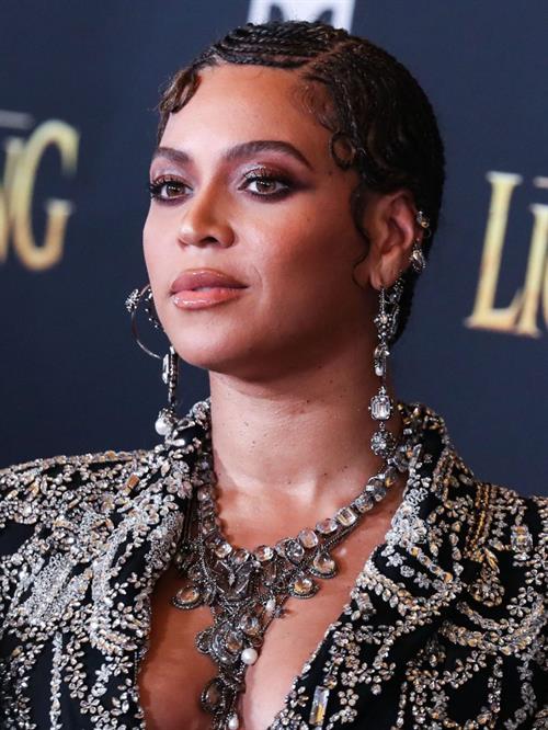 Beyonce braless boobs and areola peek showing off nice cleavage on the red carpet for the premiere of  The Lion King .






