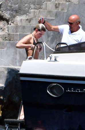 Kristen Stewart nude boobs caught topless by paparazzi tanning on a boat.
