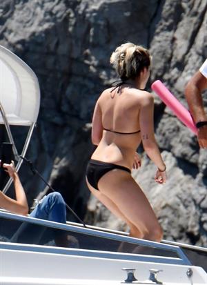 Kristen Stewart nude boobs caught topless by paparazzi tanning on a boat.
