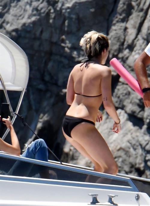 Kristen Stewart nude boobs caught topless by paparazzi tanning on a boat.
