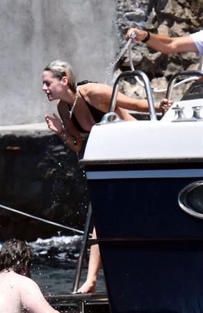 Kristen Stewart nude boobs caught topless by paparazzi tanning on a boat.
