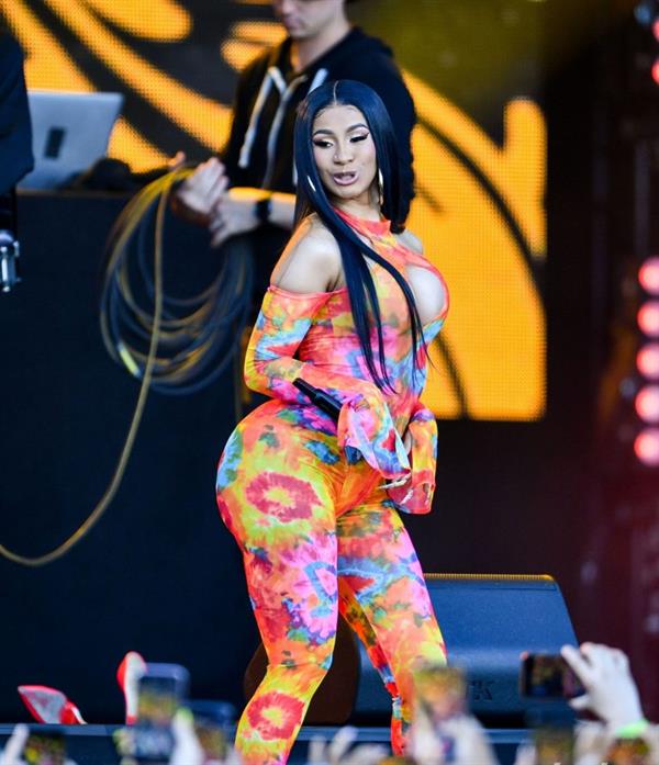 Cardi B boobs and booty on display on and off stage showing nice cleavage and her sexy ass in a tight dress.























