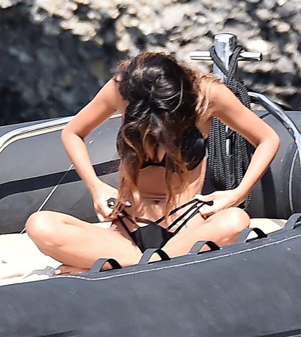 Madalina Diana Ghenea sexy ass and cleavage in a thong bikini seen by paparazzi.


