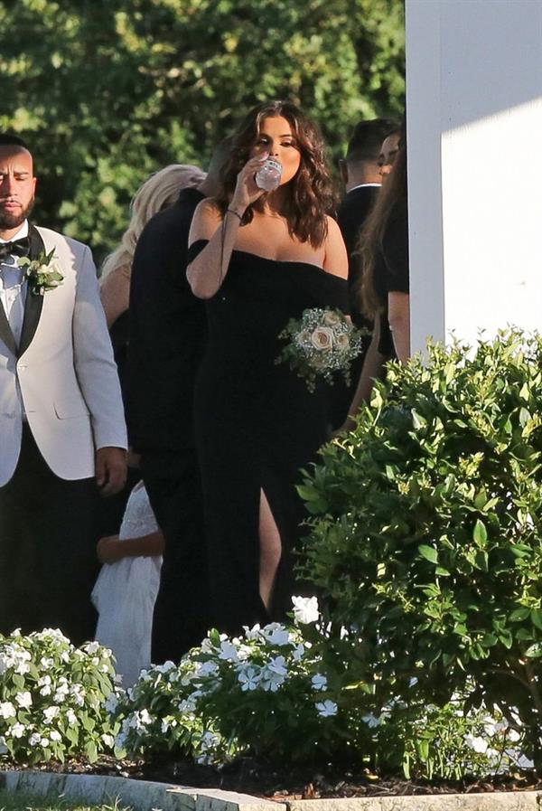 Selena Gomez sexy in a black dress for her cousins wedding showing nice cleavage seen by paparazzi.























