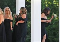 Selena Gomez sexy in a black dress for her cousins wedding showing nice cleavage seen by paparazzi.























