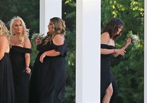 Selena Gomez sexy in a black dress for her cousins wedding showing nice cleavage seen by paparazzi.























