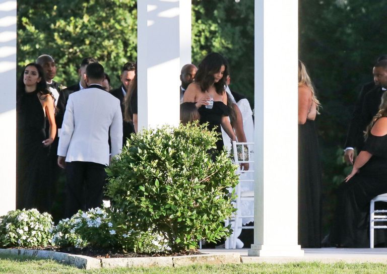 Selena Gomez Pictures Selena Gomez sexy in a black dress for her cousins wedding showing nice cleavage seen by paparazzi.