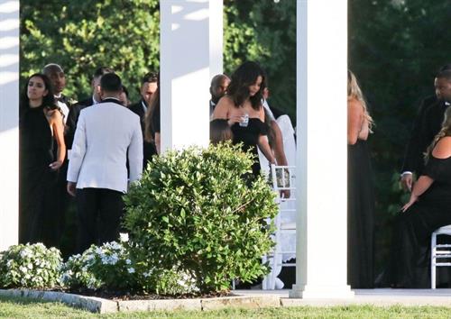 Selena Gomez Pictures Selena Gomez sexy in a black dress for her cousins wedding showing nice cleavage seen by paparazzi.