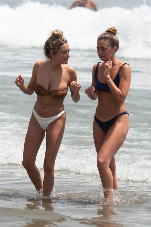 Amber Davies sexy boobs bouncing around in a loose bikini at the beach seen by paparazzi.

