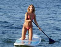 Kimberley Garner sexy model body in a pink bikini at beach seen by paparazzi.




