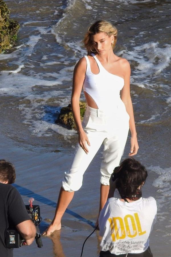 Hailey Bieber braless nipples pokies in a white top at the beach seen by paparazzi during a photo shoot.



















