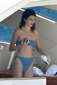 Kendall Jenner Bikini Pictures Kendall Jenner in a sexy bikini swimsuit on a yacht with Kourtney Kardashian seen by paparazzi.